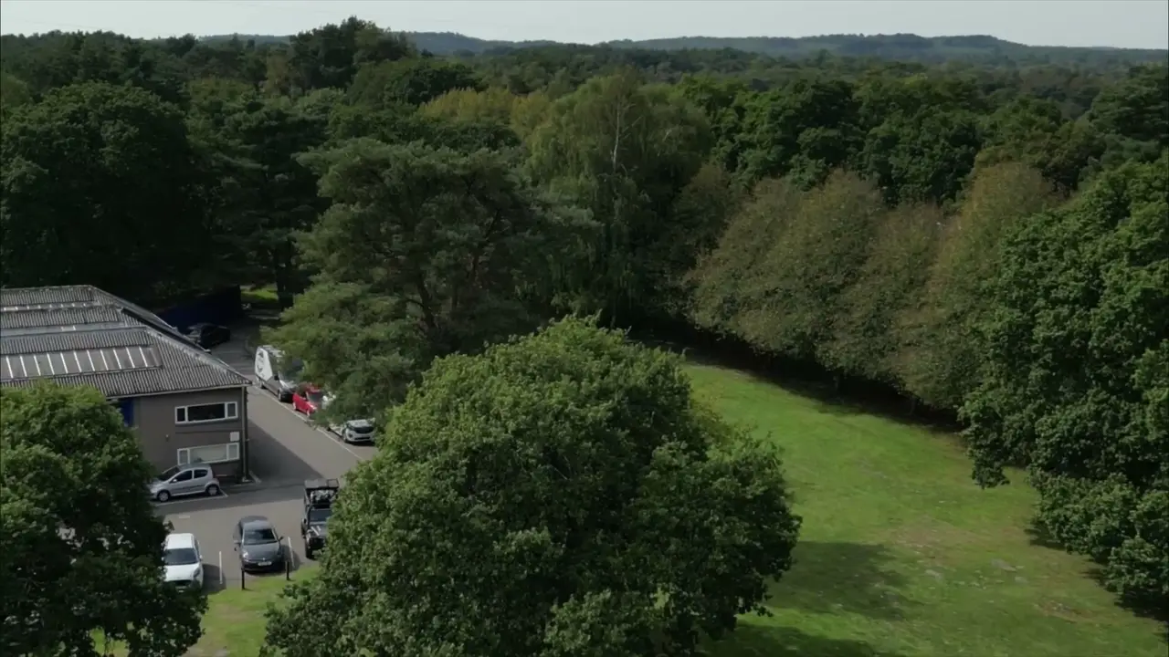 Aerial view of tree-lined grounds beside a business park